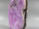 a close up of a purple stone on a white surface