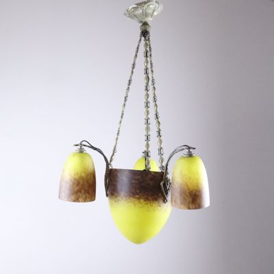a chandelier with three lights hanging from it ' s ceiling