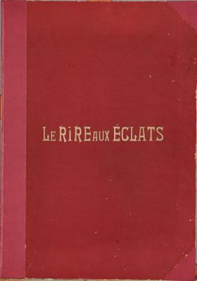 un livre rouge posé sur une table en bois