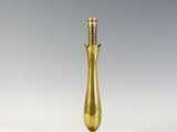 an image of a gold table lamp on a white surface