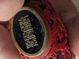 a person holding a ring with a chinese writing on it