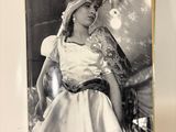 an open book with a black and white photo of a woman in a dress