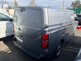 a silver van parked in a parking lot next to other cars