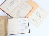 several open books sitting on top of each other on a table