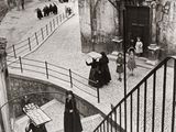 photographie en noir et blanc d'un groupe de personnes descendant un escalier
