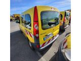 a yellow van that is parked in a parking lot