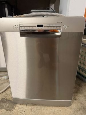 an image of a silver dishwasher sitting on top of a counter