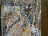 a box of food wrapped in plastic sitting on the floor