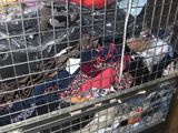 a cage filled with many different types of clothes