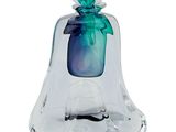 a glass bell with a green figure inside of it