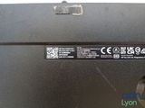 the back of a laptop computer with a small battery on top of it