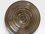 a glass plate with a brown and white design on it