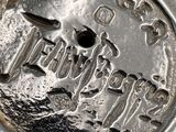 a close up of a silver coin with a bird on it