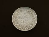 a close up of a coin on a table with a black background