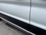 a white car with a black stripe parked on the side of the road