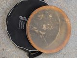 a brown frisbee on the ground next to a black bag
