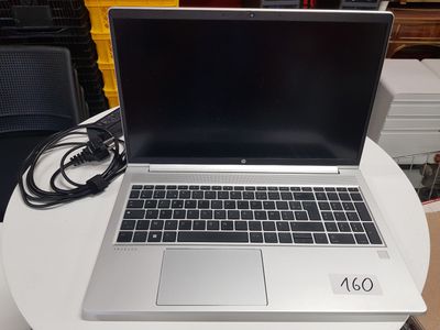 a laptop that is sitting on a table with a charger