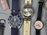 many different types of watches sitting on a table