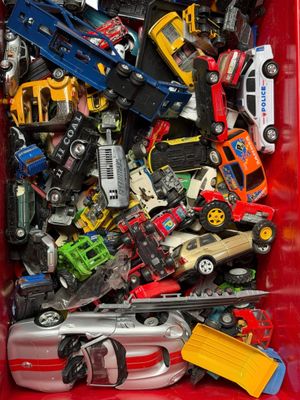 a red box filled with toy cars and other toys