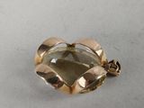 an image of a close up of a broochle on a table