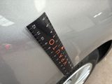 a car with a ruler attached to it ' s hood