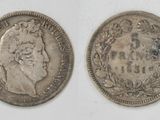 two silver coins, one with a crown and the other with a crown on it