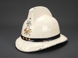 an old white hat with a black band around the brim