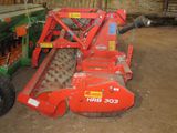 an image of a tractor and a farm equipment in a barn