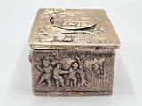 an antique silver box with an image of a man and a woman on it