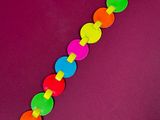 a close up of a colorful bracelet on a purple surface