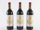three bottles of wine sitting next to each other on a white surface