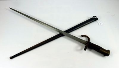pair of two swords on a white surface with a black handle