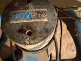 a close up of a blue pipe with a sign on it