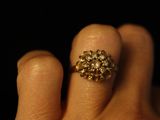 a woman ' s hand with a gold ring on it