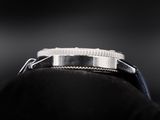 a close up of a watch sitting on top of a piece of cloth