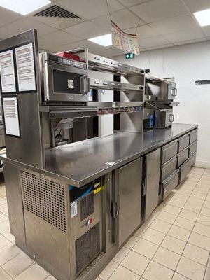 a large kitchen with stainless steel counter tops and appliances