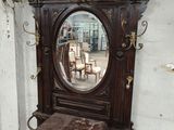 a mirror on the wall next to a table and chair