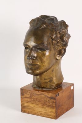 sculpture of a man ' s head on a wooden base