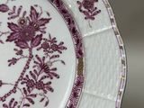 a purple and white plate with a floral design on it