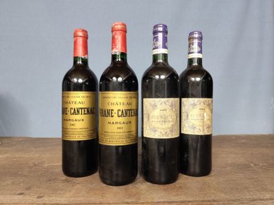 four bottles of wine are lined up on a wooden table