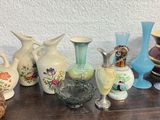 many different vases sitting on a wooden table
