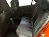 a seat in the back of a car with a remote control in it