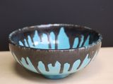 a blue and black bowl sitting on a table