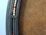 an image of a close up of a horse shoe with beads on it
