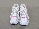 pair of white and pink running shoes with laces on them
