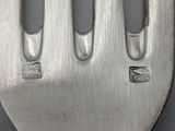 a fork that has a small piece of metal on it