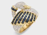 gros plan d'une bague en or avec des diamants bleus et blancs