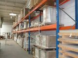 shelves in a warehouse filled with lots of boxes and pallets