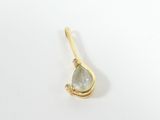 a close up of a gold plated pendant with a green tear shaped stone