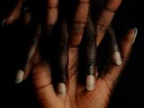 a person holding their hands up to their face